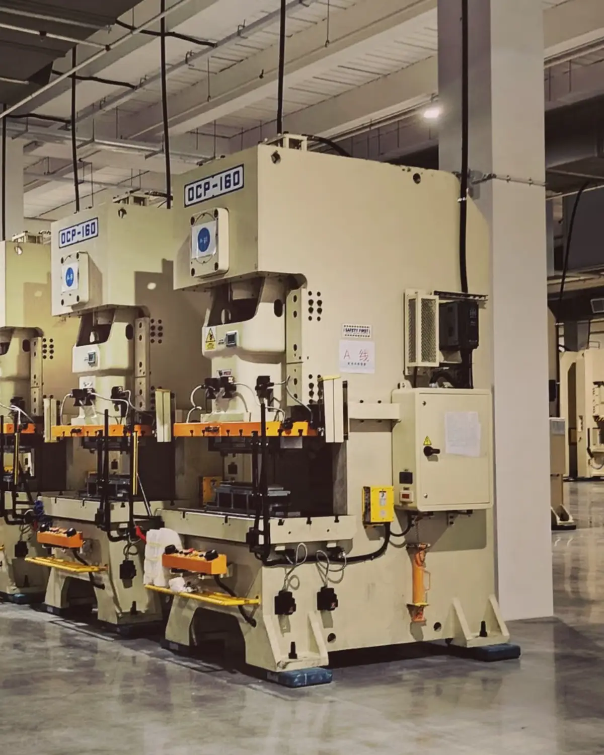 Long row of stamping presses in a manufacturing hall