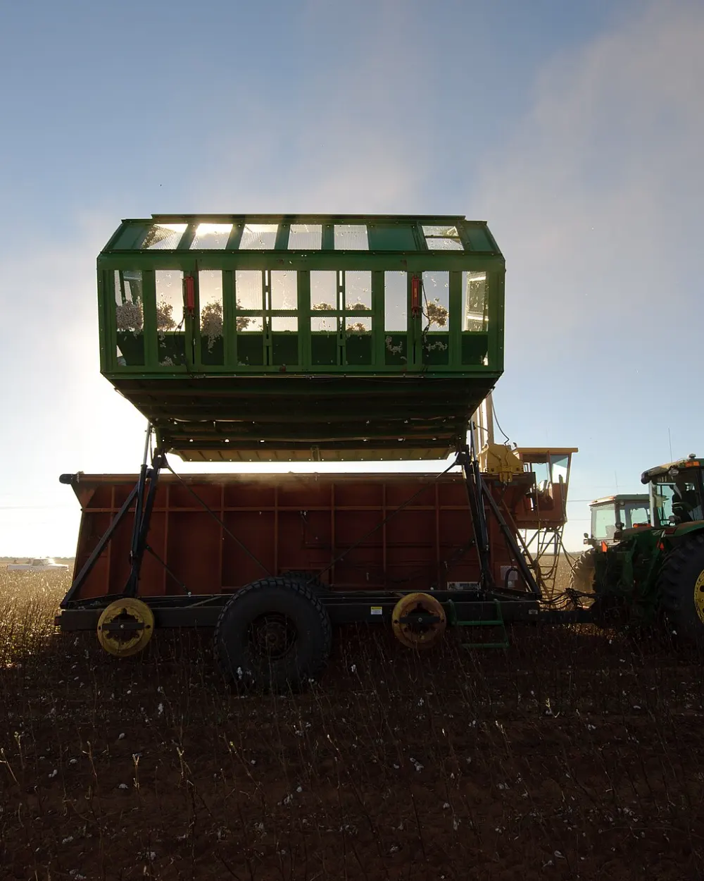 Cotton being loaded into a module builder at sunset on the South Plains near Lubbock, Texas